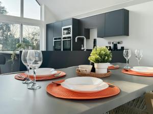a kitchen with a table with plates and wine glasses at Seafields in Sidestrand