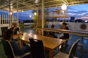 a group of people sitting at tables in a restaurant at Ringo's Foyer in Melaka