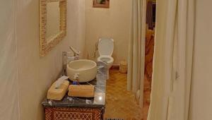 a bathroom with a sink and a toilet in a room at Ahlam luxury camp in Merzouga