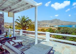 a patio with chairs and a view of the ocean at Manu Mykonos Exclusive Villa Luxury Beachside Stay with Private Pool by Quality Brand Villas in Kalafatis