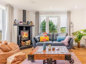 a living room with a couch and a fireplace at Go Ye Cottage in Leurbost