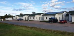 a row of houses with cars parked in a parking lot at ArcticStay Economy in Pajala