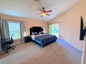 ein Schlafzimmer mit einem Bett und einem Deckenventilator in der Unterkunft Waterfront VILLA with heated Pool&Spa, sunset view, Family&Pets Friendly in Cape Coral + 16 Fotos