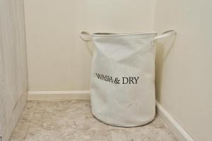 a white bucket sitting on the corner of a room at The Emerald Apartments Ibex Meanwood in Lusaka