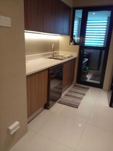 an empty kitchen with a sink and a window at Gems Havelock Apartment in Colombo