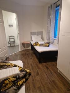a room with two beds and a table and a window at ArcticStay Economy in Pajala