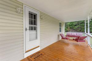 a porch with a door and two chairs and a table at 1 600 Acres Pool Pond Hidden Treasure RRG in Stanton