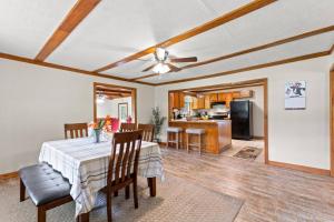a dining room with a table and a kitchen at 1 600 Acres Pool Pond Hidden Treasure RRG in Stanton