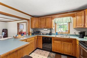 a kitchen with wooden cabinets and a sink at 1 600 Acres Pool Pond Hidden Treasure RRG in Stanton +31 photos