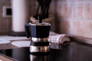 a coffee pot sitting on top of a counter at casa Aldini in Rome