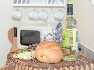 a table with a bottle of wine and a bread at Cherry Laurel in Thornton Dale +12 photos