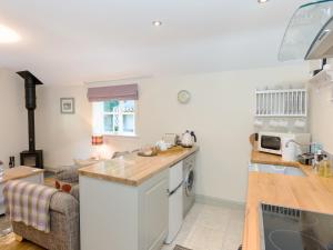 a kitchen and living room with a counter top at Cherry Laurel in Thornton Dale