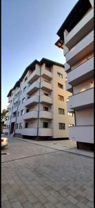 ein großes Apartmenthaus auf einem Parkplatz in der Unterkunft Central 3 Rooms Retreat - Rădăuți in Rădăuţi + 4 Fotos