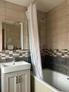 a bathroom with a sink and a tub and a shower at St. Davids Cross Hotel in St. Davids