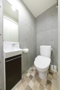 a bathroom with a white toilet and a sink at Tokyo Time Traveler 駅徒歩5分 暮らすように泊まれるホテル in Tokyo
