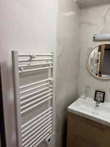 a white bathroom with a sink and a mirror at Studio à Vallouise-Pelvoux - Puy Saint Vincent, nature, rando et ski in Vallouise