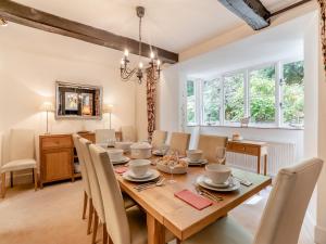 a dining room with a wooden table and chairs at The Carriage House in Llanwenarth