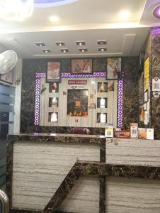 a bench in a room with a wall at Hotel Darshan Inn in Prayagraj