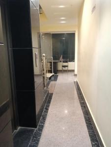 a hallway of a bathroom with a mirror at Hotel Darshan Inn in Prayagraj