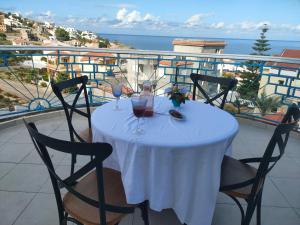 a table with two glasses of wine on a balcony at Le Chalet di Tabarka in Tabarka +14 photos