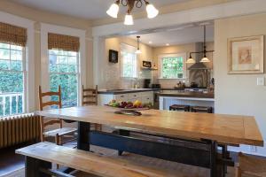 a kitchen with a table with a bowl of fruit on it at Cascade Chic 30 day minimum in Hood River