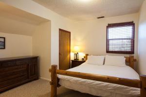 a bedroom with a bed and a dresser and a window at Heartbreak 30 day minimum in Hood River