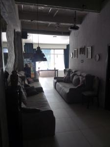 a living room with couches and a large window at Хостел Піонер in Sumy +1 photo