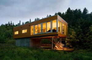 a house with glass windows on a hill at Neal Creek Retreat in Mount Hood