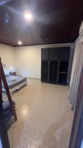 a room with a bed and a tiled floor at Mango Home Iguazú in Puerto Iguazú +16 photos