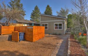 a home with an orange fence in front of a house at Mod Pod in Bend