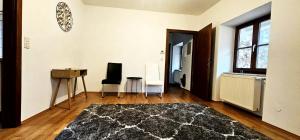 sala de estar con alfombra negra y suelo de madera en Loft Klagenfurt, en Klagenfurt