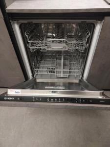 an open dishwasher with a rack of dishes in it at La Pergola in Postalesio