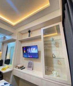 a room with a tv on a wall at RD Property in Bandung
