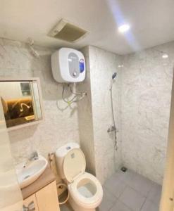 a bathroom with a toilet and a sink and a shower at RD Property in Bandung