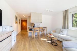 a living room and kitchen with a couch and a table at Irmella 40 by Arosa Holiday in Arosa