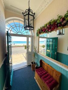 a room with a bench in front of a door at The Angove - Adults Only in Weymouth +30 photos