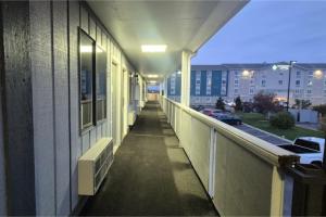 an empty hallway of a building with a balcony at Economy Inn By Townhouse Merrillville US 30 in Merrillville +23 photos