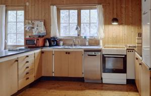 a kitchen with a sink and a stove top oven at Four-Bedroom Holiday Home In Killeberg in Killeberg