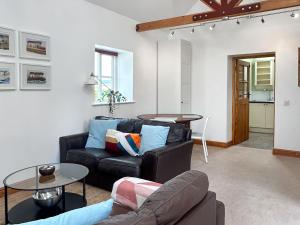 a living room with a couch and a table at Noddingway Cottage in Weare