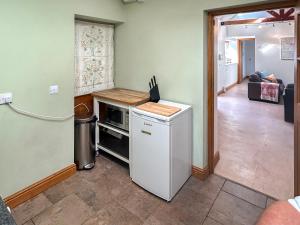 a kitchen with a refrigerator and a stove at Noddingway Cottage in Weare