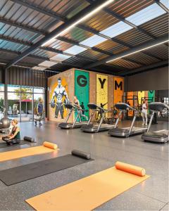 a gym with people exercising on treadmills in a gym at Tatu city Springs in Tatu City
