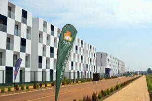 a sign on the side of a road in front of a building at Tatu city Springs in Tatu City