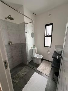 a bathroom with a shower and a toilet and a sink at Tatu city Springs in Tatu City +9 photos