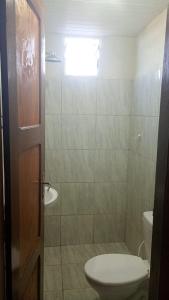 a bathroom with a toilet and a sink at Casa por do sol Flecheiras in Flecheiras