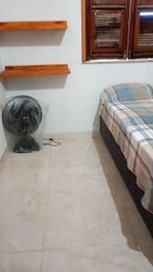 a bedroom with a bed and a tiled floor at Casa por do sol Flecheiras in Flecheiras +14 photos