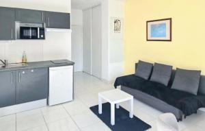 a living room with a couch and a kitchen at Gorgeous Apartment In Dunkerque With Wifi in Dunkerque