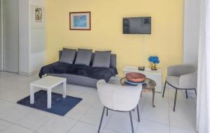 a living room with a couch and a table and chairs at Gorgeous Apartment In Dunkerque With Wifi in Dunkerque