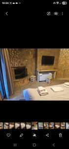 Una habitación con una cama y una chimenea de piedra. en Kalavrita Relax, en Kalavrita