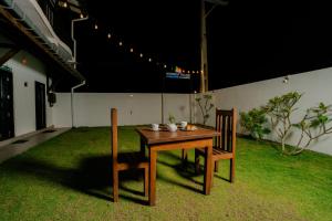 a wooden table and two chairs in a yard at Horizon Palace - Kabalana in Ahangama +52 photos