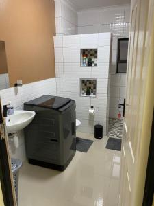 a bathroom with a sink and a toilet and a shower at Windy Dunes Self -Catering Accommodation, Luderitz in Lüderitz +9 photos